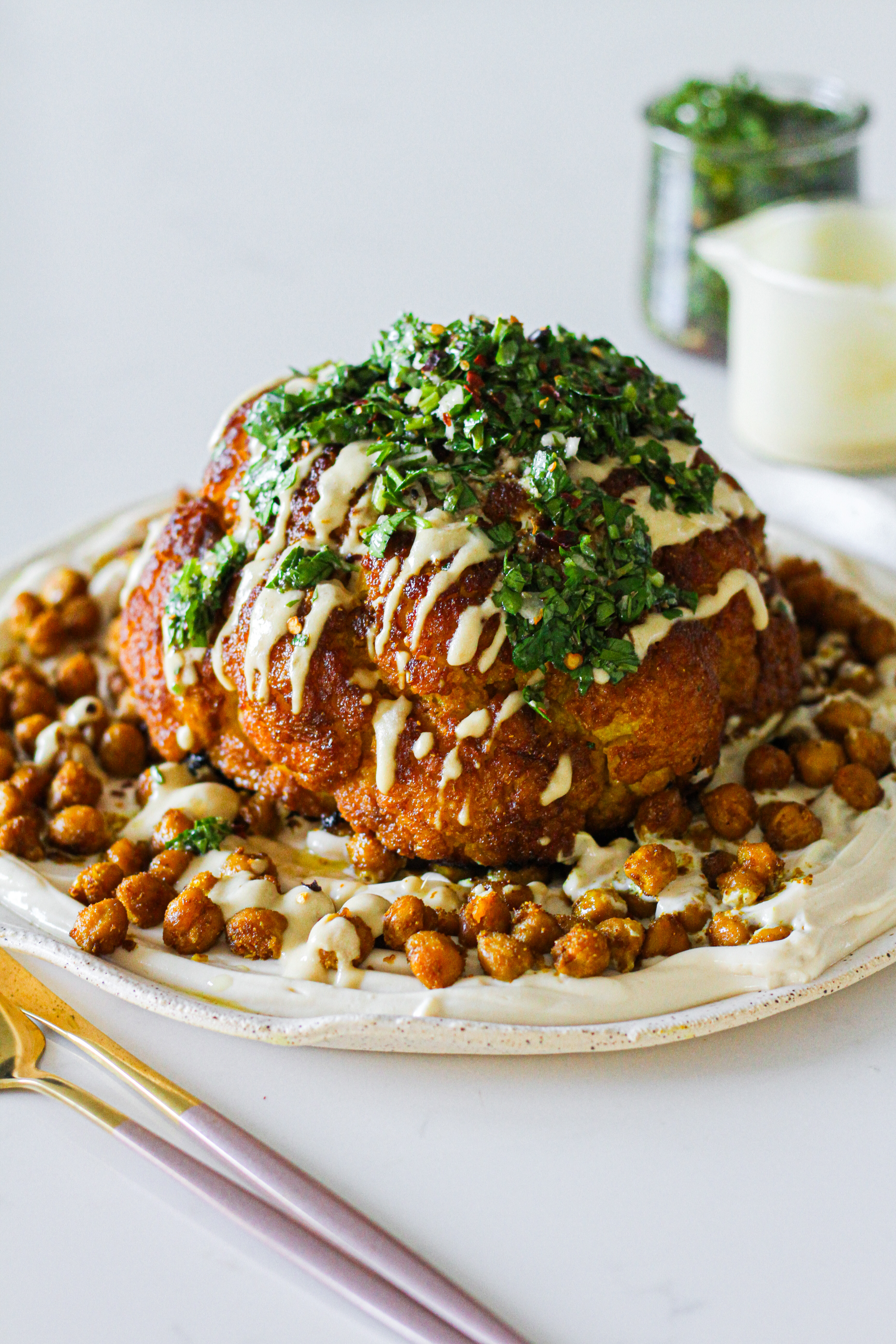 Whole Roasted Turmeric Cauliflower with Whipped Tofu Feta, Crispy Chickpeas & Chimichurri